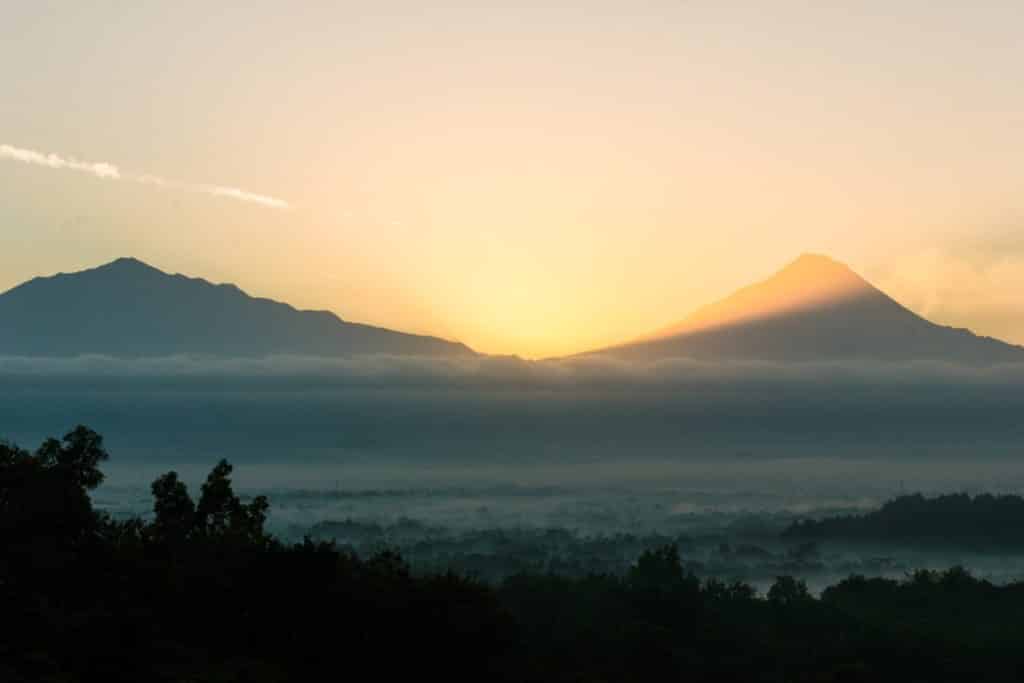 Jogja nature landscape with the sun rising over distant mountains